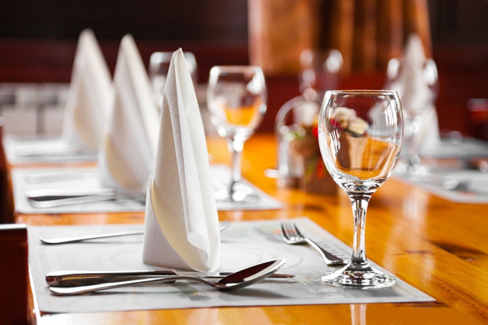 Glasses and plates on table in restaurant